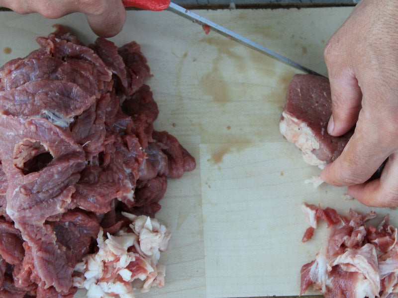 Preparing fresh meat for a homemade dog food recipe